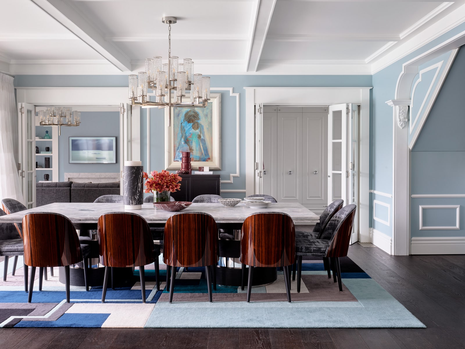 The tones of blue found around the dining room offer a beautiful juxtaposition with the warmth from the stunning dining chairs.
